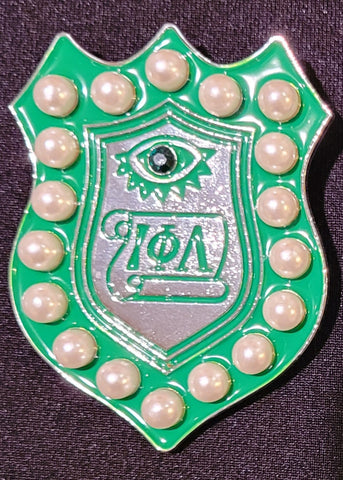 Pearl and emerald emblem pin